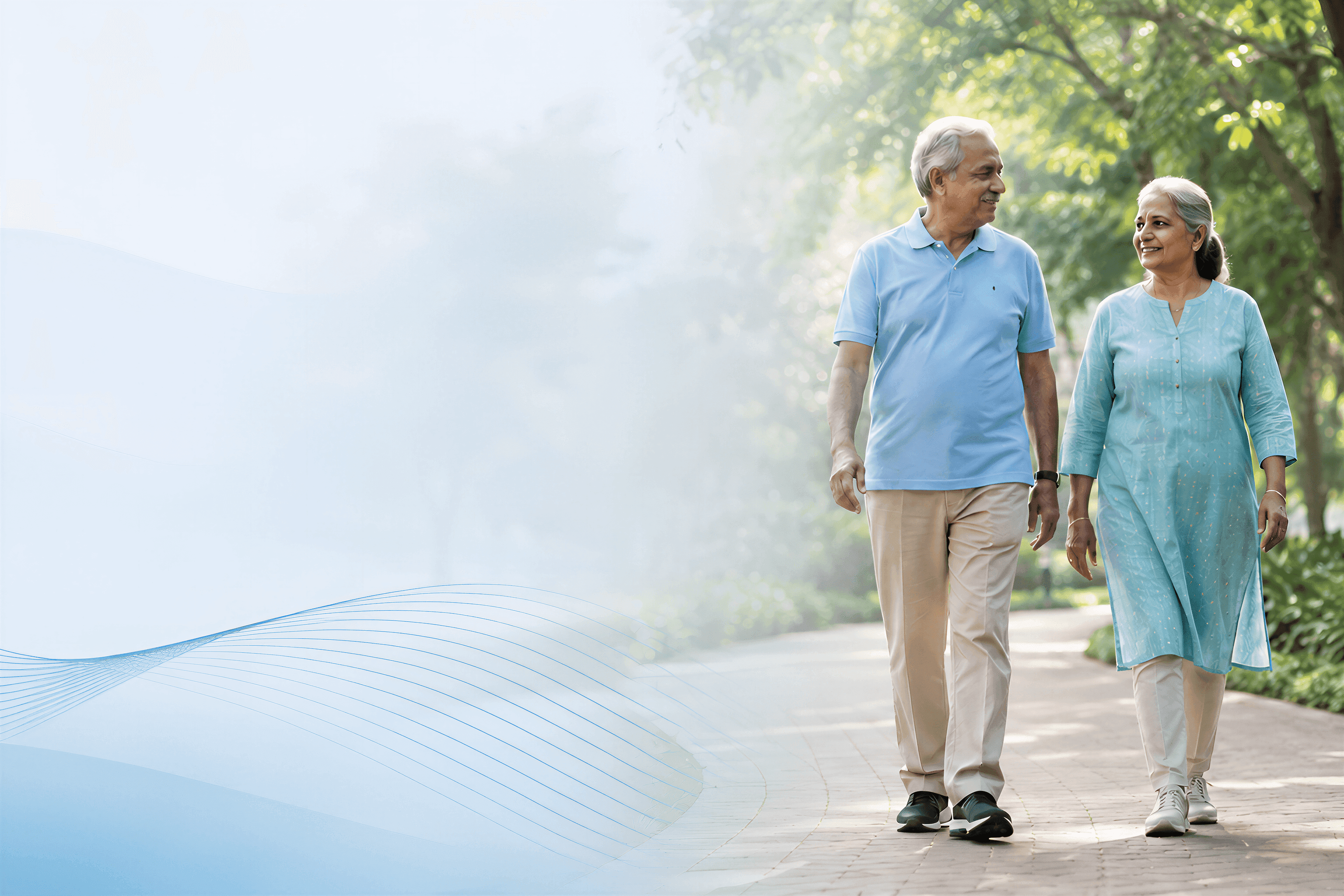 An older couple walking together along a tree-lined park path, talking and smiling